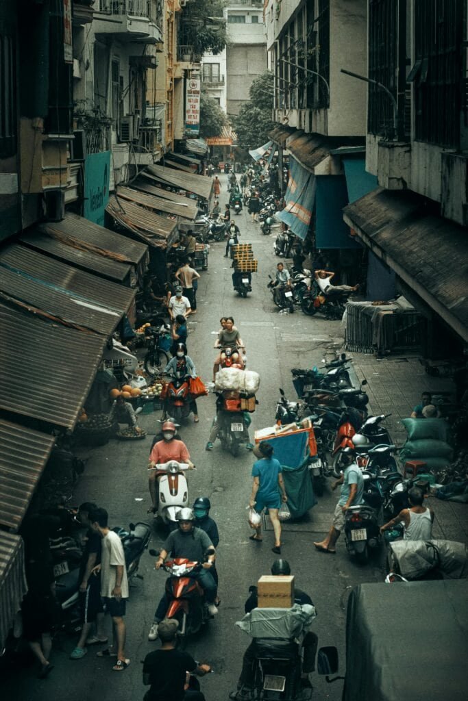 Hanoi Old Quarter streets with scooters and street food vendors Vietnam Travel Guide 2025 | Top Places to Visit, Things to Do & Travel Tips Hanoi Old Quarter streets with scooters and street food vendors.