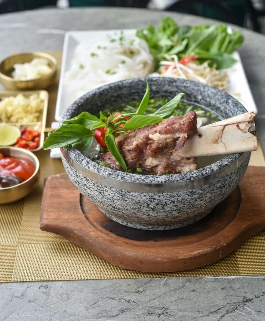 Pho – Rice noodle soup with beef or chicken Vietnam Travel Guide 2025 | Top Places to Visit, Things to Do & Travel Tips Pho – Rice noodle soup with beef or chicken