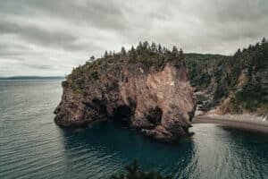 Arch Rock Formation Extending Towards Sea, Chance Cove, NL, Canada