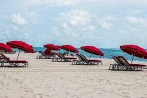 Deckchairs and Umbrellas on a Sandy Beach, Miami Beach, FL, United States