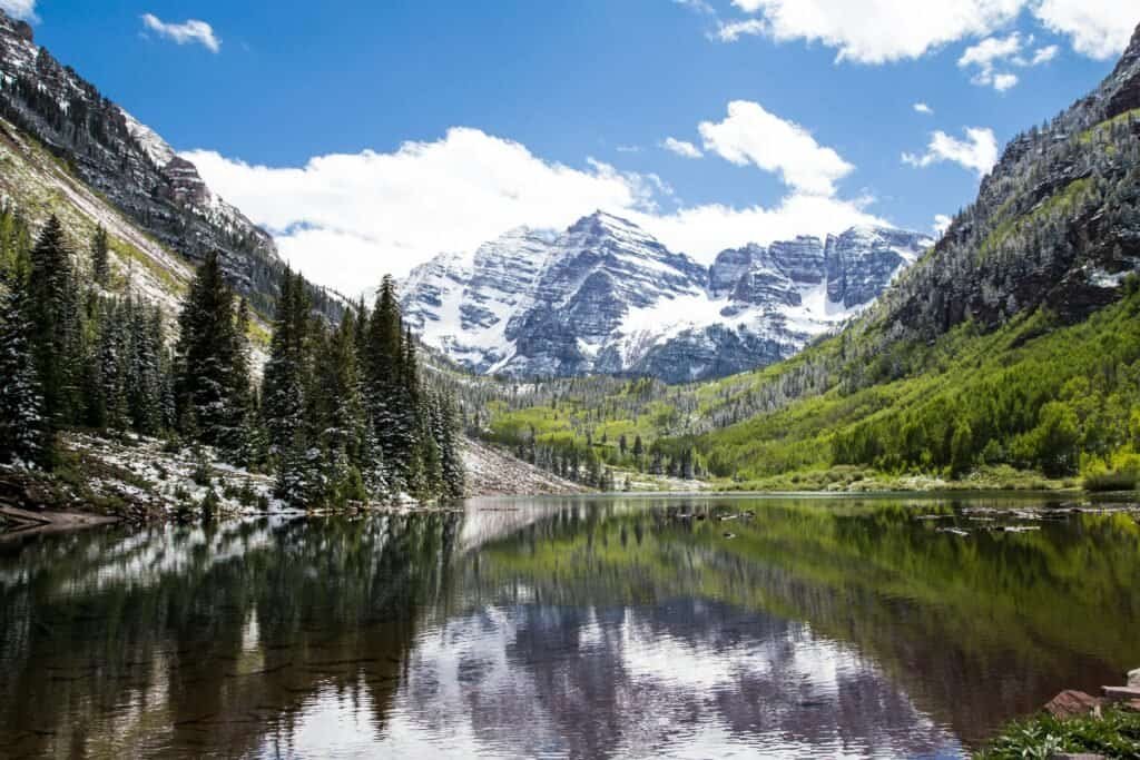 Green Pine Trees Near Lake and Snow Covered Mountain, USA