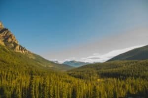 Green forest in mountain valley under blue sky Canada Best Time to Visit Canada 2026 – Month by Month Weather, Costs & Tips Green forest in mountain valley under blue sky, Canada