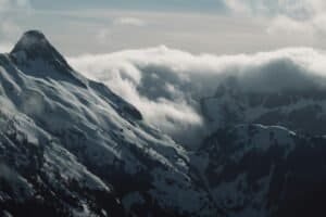 Snow Covered Mountains Under a Cloudy Sky, BC, Canada