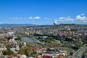 A vibrant aerial view of Tbilisi cityscape with Kura River, Georgia