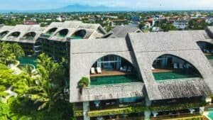 Aerial view of a contemporary resort in Bali, showcasing unique design with lush green landscapes and a pool