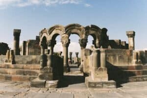 Ancient ruined arches of Zvartnots Cathedral under clear sky in Armenia