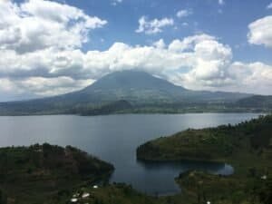 Beautiful landscape of a lake with mountains under a cloudy sky in Butaro, Rwanda