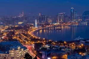 Captivating urban nightscape of Baku with skyline and Caspian Sea reflecting city lights, Azerbaijan