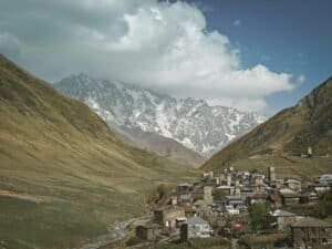 Charming mountain village nestled in a picturesque valley with soaring snow-capped peaks, Georgia