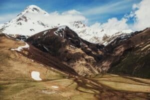 Panoramic view of Mount Kazbek above rugged landscape in Kazbegi, Georgia