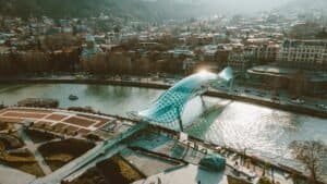 Scenic aerial shot of Tbilisi showcasing the Bridge of Peace over the Kura River, Georgia