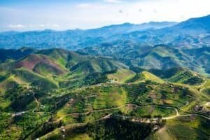 Stunning aerial landscape of vibrant green hills and terraced fields in Rwanda's countryside, Rwanda