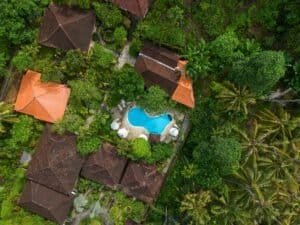 Stunning aerial shot of tropical villa with pool surrounded by lush greenery in Bali